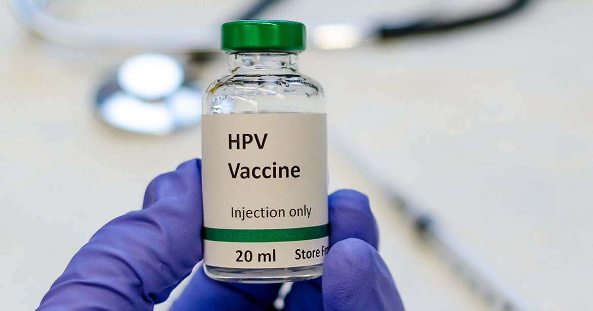 HPV vaccine vial with syringe and stethoscope at the background